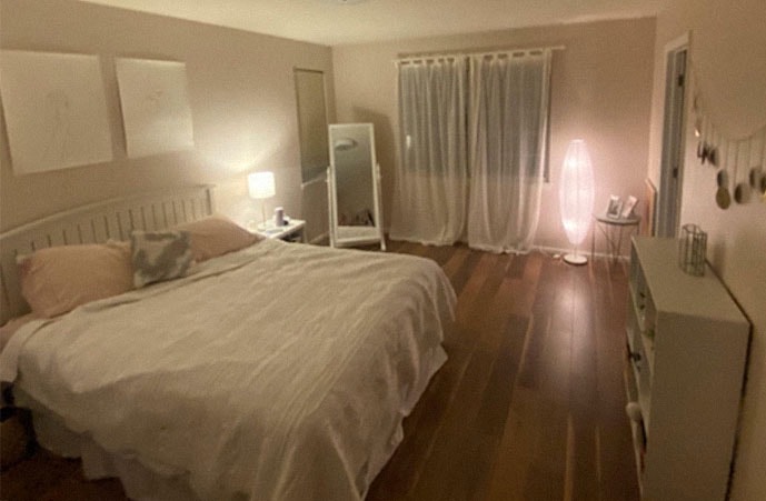 Cozy bedroom with warm lighting and neatly made bed after cleaning